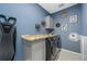 Modern laundry room with a gray countertop, updated washer and dryer and unique wall decor at 19620 Eagle Crest Dr, Lutz, FL 33549