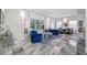 Bright, expansive living room with blue velvet couches, modern floors and sheer white curtains at 19620 Eagle Crest Dr, Lutz, FL 33549