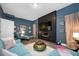 Living room with an electric fireplace, a large screen TV and blue walls at 19620 Eagle Crest Dr, Lutz, FL 33549