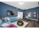Stylish living area featuring a comfortable blue sofa, gold coffee table, and hardwood flooring at 19620 Eagle Crest Dr, Lutz, FL 33549