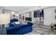 Spacious living area with modern floors, blue velvet furniture, and a stylish bar area at 19620 Eagle Crest Dr, Lutz, FL 33549