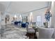 Bright, spacious living room features blue velvet sofas, modern floor, and dining space beyond at 19620 Eagle Crest Dr, Lutz, FL 33549