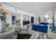 Stylish living room featuring a modern glass table, adjacent to kitchen with sleek countertops at 19620 Eagle Crest Dr, Lutz, FL 33549