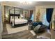 A spacious main bedroom boasts a canopy bed, accent wall, and luxury decor at 19620 Eagle Crest Dr, Lutz, FL 33549