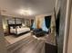 Spacious main bedroom featuring a four-poster bed, sitting area, and stylish décor at 19620 Eagle Crest Dr, Lutz, FL 33549