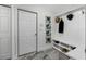 Entryway mudroom featuring a white bench with shoe storage, coat hooks, and decorative wall art at 19620 Eagle Crest Dr, Lutz, FL 33549