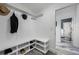 Mudroom with built-in bench, shelving, and hooks, offering a practical storage solution at 19620 Eagle Crest Dr, Lutz, FL 33549
