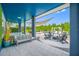 Covered patio featuring comfortable lounge seating, a fire pit, and a view of the pool and backyard at 19620 Eagle Crest Dr, Lutz, FL 33549