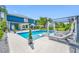 A luxurious pool with in-pool seating and poolside lounge area, perfect for relaxation and entertainment at 19620 Eagle Crest Dr, Lutz, FL 33549