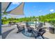 Backyard pool area with a shaded seating area, fire pit, and outdoor dining table, perfect for entertaining at 19620 Eagle Crest Dr, Lutz, FL 33549