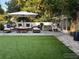 A serene backyard offers ample seating, a luxurious hot tub, and lush green turf, perfect for relaxation at 2278 Republic Dr, Dunedin, FL 34698