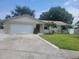 Charming single-story home with a well-manicured front yard and attached two-car garage at 2278 Republic Dr, Dunedin, FL 34698