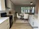 Modern kitchen seamlessly extends into the dining area with new appliances, cabinets, and hardwood floors at 2278 Republic Dr, Dunedin, FL 34698