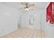 Open concept bedroom featuring tile flooring, bright walls, and a ceiling fan at 2306 W Ivy St, Tampa, FL 33607