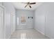 Simple bedroom with neutral colors, tile flooring, closet, and a bright window, creating a serene retreat at 2306 W Ivy St, Tampa, FL 33607