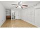 Bedroom featuring ceiling fan, tile floor, closet, and window with sheer curtain at 2306 W Ivy St, Tampa, FL 33607