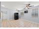 Open dining area with tile floors, ceiling fans, and natural light, creating a comfortable and inviting space at 2306 W Ivy St, Tampa, FL 33607