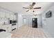 Bright kitchen featuring tile floors, white cabinetry, and modern appliances, offering a functional and inviting space at 2306 W Ivy St, Tampa, FL 33607