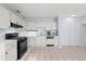 Well-equipped kitchen with tile floors, white cabinets, and modern appliances creating a clean and efficient cooking area at 2306 W Ivy St, Tampa, FL 33607