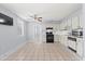 Spacious kitchen with tile floors, black appliances, and white cabinetry, perfect for cooking and entertaining at 2306 W Ivy St, Tampa, FL 33607