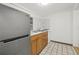 Kitchen featuring a stainless steel refrigerator, wood cabinets, and granite countertops at 2306 W Ivy St, Tampa, FL 33607
