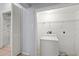 Functional laundry area with washer, storage shelves, and ample space for laundry tasks at 2306 W Ivy St, Tampa, FL 33607