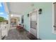 Charming front porch with white trim, classic lighting, and inviting seating at 2306 W Ivy St, Tampa, FL 33607