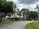 Community clubhouse with red tile roof surrounded by lush landscaping offers resident amenities at 2650 Countryside Blvd # C106, Clearwater, FL 33761