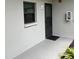 Exterior entrance with a door, a window with blinds, and a fire extinguisher box at 2650 Countryside Blvd # C106, Clearwater, FL 33761