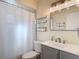 Cozy bathroom with white shower curtain, stylish vanity, and well-lit mirror at 2707 Lakeville Dr, Tampa, FL 33618
