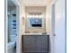 Elegantly designed bathroom with gray vanity, marble countertop, and modern lighting fixtures at 2707 Lakeville Dr, Tampa, FL 33618