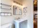 Charming bathroom with modern vanity, stylish shelves, and warm, inviting lighting at 2707 Lakeville Dr, Tampa, FL 33618