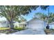 Charming one-story home with a well-manicured lawn and mature tree at 2707 Lakeville Dr, Tampa, FL 33618