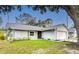 Charming single-story home featuring a well-manicured lawn, attached garage, and light-colored facade at 2707 Lakeville Dr, Tampa, FL 33618