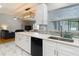 Bright kitchen with white cabinetry, modern appliances, and a seamless connection to the living area at 2707 Lakeville Dr, Tampa, FL 33618