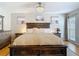 Comfortable bedroom featuring a large bed with a decorative ceiling fan and ample natural light at 2707 Lakeville Dr, Tampa, FL 33618