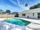 Backyard pool with privacy fence and beautiful landscaping provides the perfect relaxation spot at 2707 Lakeville Dr, Tampa, FL 33618
