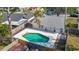 Aerial view of a backyard featuring a kidney-shaped pool with a concrete deck and fenced yard at 2707 Lakeville Dr, Tampa, FL 33618