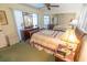 A bedroom featuring mirrored wall, ceiling fan, and comfortable bed at 2854 60Th N St, St Petersburg, FL 33710