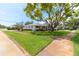 A beautiful single-story house with a large tree on a well-maintained lawn from a side angle at 2854 60Th N St, St Petersburg, FL 33710