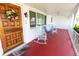 Inviting front porch features rocking chairs and a decorative wreath on the wood door at 2854 60Th N St, St Petersburg, FL 33710