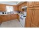 Classic kitchen featuring wood cabinets, tile flooring, and a white electric range at 2854 60Th N St, St Petersburg, FL 33710