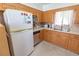 Traditional kitchen with wood cabinets, tile backsplash, and classic appliances at 2854 60Th S St, St Petersburg, FL 33710