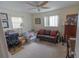 Neutral-toned living room with ceiling fan, comfortable seating, and natural lighting at 2854 60Th N St, St Petersburg, FL 33710