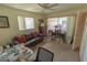 Neutral-toned living room with ceiling fan, comfortable seating, and pool access at 2854 60Th N St, St Petersburg, FL 33710
