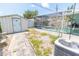 The backyard of the house has a screened-in pool, a storage shed, and a paved walkway with a condenser at 2854 60Th S St, St Petersburg, FL 33710