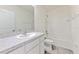 This bathroom features a vanity with sleek countertop, modern fixtures, and a tub, offering a refreshing experience at 2882 Peony Prairie Ln, Wesley Chapel, FL 33543