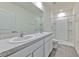 Bright bathroom featuring a dual sink vanity, a large mirror, and a clean shower stall, perfect for a fresh start at 2882 Peony Prairie Ln, Wesley Chapel, FL 33543