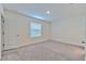 Spacious bedroom featuring plush carpet, window bringing in natural light, and neutral paint, creating a cozy retreat at 2882 Peony Prairie Ln, Wesley Chapel, FL 33543