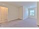 This bright bedroom offers plush carpeting, natural light, and neutral walls, creating a serene and inviting atmosphere at 2882 Peony Prairie Ln, Wesley Chapel, FL 33543